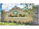 Elegant Magnolia Park community entrance sign with lush landscaping and decorative details at 539 Tanaro Ln, Haines City, FL 33844