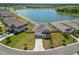 Aerial shot of the home in a lakeside community, complete with a well-kept lawn and a lengthy driveway at 5463 Arlington River Dr, Lakeland, FL 33811