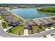 Aerial shot of the home in a lakeside community showing lush landscaping and a lengthy driveway at 5463 Arlington River Dr, Lakeland, FL 33811