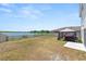 Backyard features a patio with furniture, waterfront view, and fenced yard, perfect for outdoor activities at 5463 Arlington River Dr, Lakeland, FL 33811