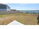 Spacious backyard offers a tranquil waterfront view, a fence, and a patio area, perfect for outdoor living at 5463 Arlington River Dr, Lakeland, FL 33811
