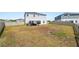 Aerial view of the backyard featuring a patio with seating, grassy area, and a privacy fence at 5463 Arlington River Dr, Lakeland, FL 33811