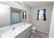 Bright bathroom featuring a dual sink vanity, and shower with glass doors at 5463 Arlington River Dr, Lakeland, FL 33811