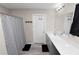 Bathroom showcasing dual sinks with ample counter space, shower with patterned curtain, and neutral walls at 5463 Arlington River Dr, Lakeland, FL 33811