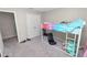 Carpeted bedroom boasts a white loft bed with a ladder and extra space underneath for relaxing at 5463 Arlington River Dr, Lakeland, FL 33811