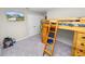 Bedroom includes mounted TV, and bed with ladder and desk at 5463 Arlington River Dr, Lakeland, FL 33811