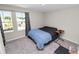 Bedroom features a large window, soft carpet, and a comfortable bed with a side table at 5463 Arlington River Dr, Lakeland, FL 33811