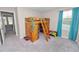 Bedroom features wooden loft bed with ladder and storage space, as well as blue curtains for the window at 5463 Arlington River Dr, Lakeland, FL 33811