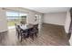 Open floor plan that showcases backyard view in combination with wooden dining table at 5463 Arlington River Dr, Lakeland, FL 33811