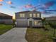 Charming two-story home featuring a two-car garage, well-maintained lawn, and inviting curb appeal at 5463 Arlington River Dr, Lakeland, FL 33811