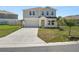 Charming two-story home with a well-manicured lawn, long driveway, and inviting curb appeal at 5463 Arlington River Dr, Lakeland, FL 33811