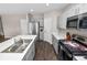 Open kitchen with stainless steel appliances, quartz counters, and grey cabinets at 5463 Arlington River Dr, Lakeland, FL 33811