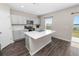 Kitchen featuring stainless appliances, quartz countertops, gray cabinets and a view of the lake at 5463 Arlington River Dr, Lakeland, FL 33811