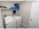 Laundry room features a washing machine, dryer, and shelving unit for storage at 5463 Arlington River Dr, Lakeland, FL 33811