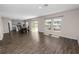 Open-concept living area with wood floors, great light, and a dining area with backyard access at 5463 Arlington River Dr, Lakeland, FL 33811