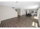 Spacious living area featuring wood floors flowing into a dining and kitchen area at 5463 Arlington River Dr, Lakeland, FL 33811