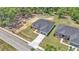Aerial view of a single-story home with a gray roof, driveway, and landscaped front yard on a sunny day at 5508 Odom, Lakeland, FL 33809