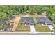 Aerial view of a single-story home with a gray roof, driveway, and landscaped front yard on a sunny day at 5508 Odom, Lakeland, FL 33809