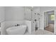 Bathroom with tub, glass shower and marble tiled floors at 5508 Odom, Lakeland, FL 33809