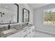 Bathroom featuring dual vanities with marble counters, and large windows at 5508 Odom, Lakeland, FL 33809