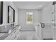 Bathroom with dual vanities, marble counters, garden tub and glass shower at 5508 Odom, Lakeland, FL 33809