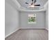 Bedroom features tray ceiling, fan, and a window overlooking greenery at 5508 Odom, Lakeland, FL 33809