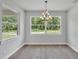 Bright dining room with wood floors, chandelier, and large windows overlooking a green landscape at 5508 Odom, Lakeland, FL 33809