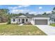Charming single-story home with a gray roof, gray garage door, landscaped front yard, and inviting entrance at 5508 Odom, Lakeland, FL 33809