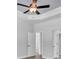 Bedroom featuring tray ceiling, fan, and a door to en suite bathroom at 5508 Odom, Lakeland, FL 33809