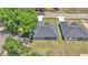 An aerial view of a newly built home with a large backyard, complemented by lush trees at 5512 Odom Rd, Lakeland, FL 33809
