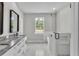 Modern bathroom features double vanity with marble countertop, a separate soaking tub, and walk-in shower at 5512 Odom Rd, Lakeland, FL 33809