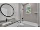 Modern bathroom features a vanity with striking marble countertop and a shower-tub combo with gray subway tiles at 5512 Odom Rd, Lakeland, FL 33809