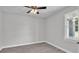 Bright, simple bedroom with a ceiling fan, wood-look floors and a window providing natural light at 5512 Odom Rd, Lakeland, FL 33809