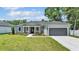 Charming single-story home features a manicured lawn and a welcoming front entrance with decorative columns at 5512 Odom Rd, Lakeland, FL 33809