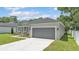 Charming single-story home features a manicured lawn and a welcoming front entrance with decorative columns at 5512 Odom Rd, Lakeland, FL 33809