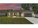 Charming single-story home features a manicured lawn and a welcoming front entrance with decorative columns at 5512 Odom Rd, Lakeland, FL 33809