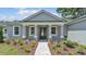 Charming home showcasing a welcoming front porch, manicured landscaping, and stylish architectural details at 5512 Odom Rd, Lakeland, FL 33809
