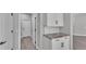 Hallway with white cabinets, granite countertop, and easy access to nearby rooms creating practical space at 5512 Odom Rd, Lakeland, FL 33809