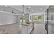 Stylish kitchen featuring a center island, modern fixtures, and an open view to the living area at 5512 Odom Rd, Lakeland, FL 33809