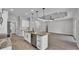 Open kitchen with island, granite countertops, stainless appliances, and seamless flow into the living area at 5512 Odom Rd, Lakeland, FL 33809