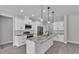 Bright kitchen features white cabinets, stainless appliances, granite countertops, and island with pendant lighting at 5512 Odom Rd, Lakeland, FL 33809