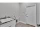Functional laundry room with sink, neutral color scheme, and plenty of space for laundry-related tasks at 5512 Odom Rd, Lakeland, FL 33809