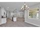Open concept living space with kitchen island, dining area, and large windows with ample natural light at 5512 Odom Rd, Lakeland, FL 33809