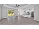 Open-concept living area showcasing a modern kitchen, ample space, and sliding doors to the backyard at 5512 Odom Rd, Lakeland, FL 33809