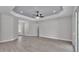 Open living area boasting contemporary flooring, tray ceiling, and seamless flow to the kitchen at 5512 Odom Rd, Lakeland, FL 33809