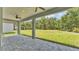 Spacious outdoor patio with ceiling fans overlooking the grassy backyard, perfect for entertaining at 5512 Odom Rd, Lakeland, FL 33809