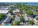 An aerial view of a home with a backyard pool, showcasing its proximity to the lake and the city at 649 Ave J Nw, Winter Haven, FL 33881