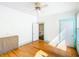 Spacious bedroom with hardwood floors, ceiling fan, and large windows, and access to the ensuite at 649 Ave J Nw, Winter Haven, FL 33881