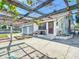 Charming home exterior featuring a covered patio, water feature, and verdant foliage at 649 Ave J Nw, Winter Haven, FL 33881