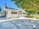 Charming single-story home featuring white siding, brown shutters, a brick chimney, and a well-maintained front yard at 649 Ave J Nw, Winter Haven, FL 33881